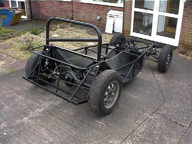Bare rolling chassis, good view of the Ford Escort live axle.